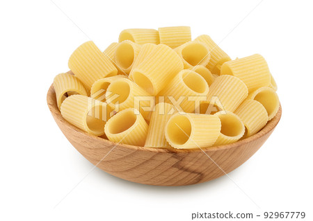 raw italian pasta in wooden bowl isolated on white background. Mezze Maniche Rigate Bronze die 92967779