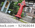 An old fire extinguisher in the garden of the temple 92968644