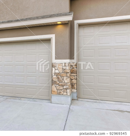 Square Three-car garage exterior with light brown sidings 92969345
