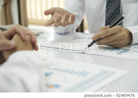 Asisan businessman teamwork meeting and discussing the investment data and report graph. Asisan businessman teamwork meeting and discussing the investment data and report graph. 92969476