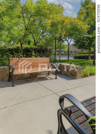 Vertical White puffy clouds Two benches in a small residential park at San Marcos, Californi 92970096