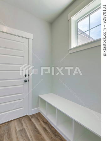Vertical Mudroom interior with a seating area with shoe storage at the bottom Vertical Mudroom interior with a seating area with shoe storage at the bottom 92970131