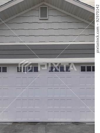 Vertical Whispy white clouds Traditional garage exterior with white and gray tone color palet 92970142