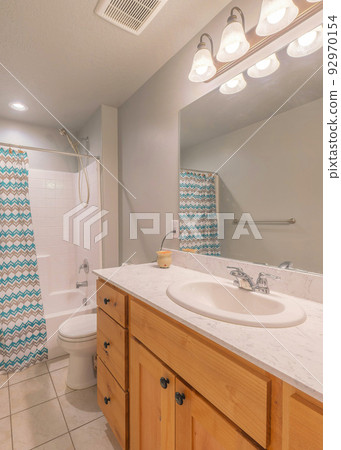 Vertical Bathroom interior with decorative liquid soap owl bottle on the marble top 92970154