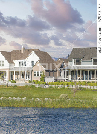 Vertical Puffy clouds at sunset Oquirrh Lake at the front of large residential buildings at Dayb Vertical Puffy clouds at sunset Oquirrh Lake at the front of large residential buildings at Dayb 92970179