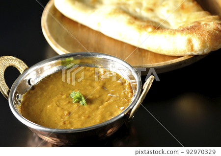 Keema curry and naan using mutton are photographed against a black background 92970329