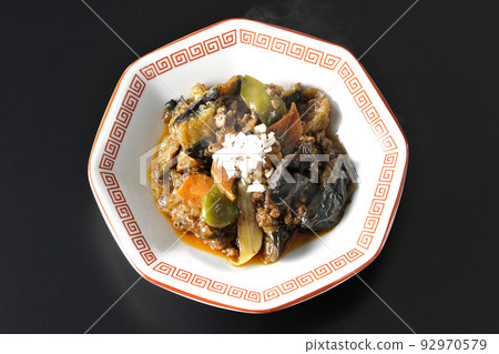 A bird's-eye view of a hot mapo eggplant served on an octagonal Chinese dish with a black background A bird's-eye view of a hot mapo eggplant served on an octagonal Chinese dish with a black background 92970579