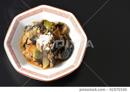 A bird's-eye view of a hot mapo eggplant served on an octagonal Chinese dish with a black background A bird's-eye view of a hot mapo eggplant served on an octagonal Chinese dish with a black background 92970580