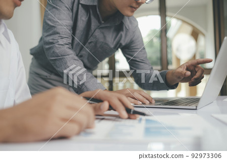 Close up asisan businessman teamwork meeting and discussing the investment data and report graph. Close up asisan businessman teamwork meeting and discussing the investment data and report graph. 92973306