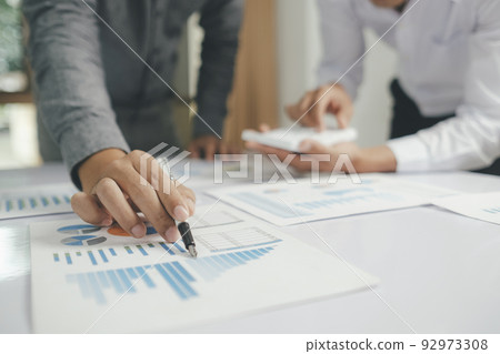 Asisan businessman teamwork meeting and discussing the investment data and report graph. Asisan businessman teamwork meeting and discussing the investment data and report graph. 92973308