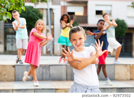 Young boys and girls dancing outdoors Young boys and girls dancing outdoors 92973502