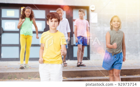 Young girl and boys coming downstairs Young girl and boys coming downstairs 92973714