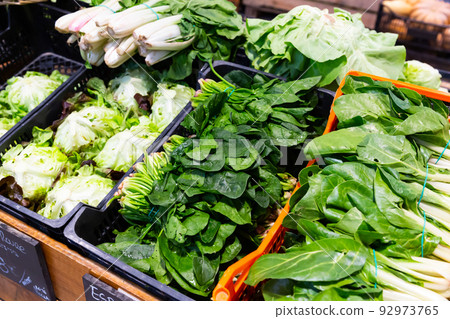 Counter of greengrocery with fresh greens Counter of greengrocery with fresh greens 92973765