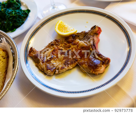 Italian dish - traditional veal chop with lemon 92973778