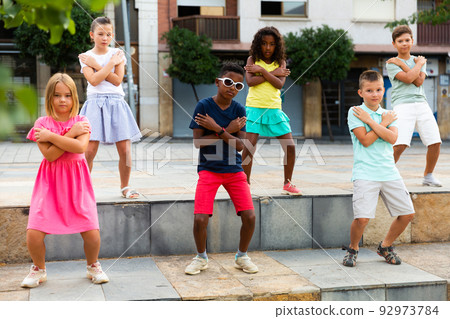 Group of kids performing street dance outdoors Group of kids performing street dance outdoors 92973784