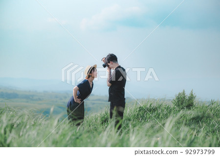 Man and woman taking pictures in nature Man and woman taking pictures in nature 92973799