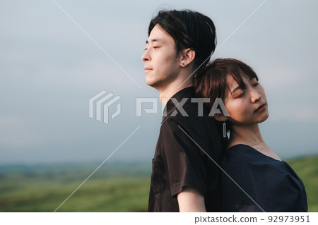 man and woman back to back in nature 92973951