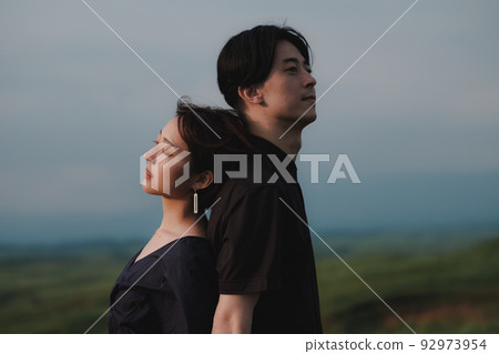 man and woman back to back in nature 92973954