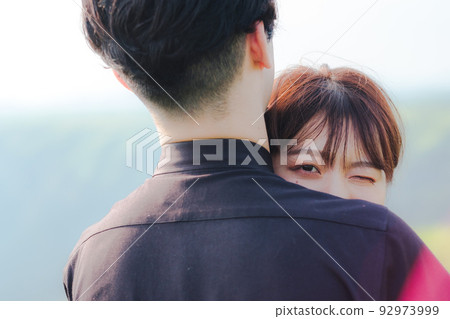 Men and women hugging Men and women hugging 92973999