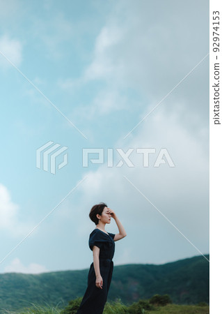 A woman who feels the wind in nature A woman who feels the wind in nature 92974153