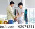 Two people Asian romantic cute teenage boys gay men lover couple stand  help each other get dressed 92974231