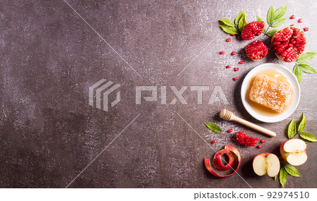 Rosh hashanah (Jewish New Year holiday), Concept of traditional or religion symbols on dark stone background. Rosh hashanah (Jewish New Year holiday), Concept of traditional or religion symbols on dark stone background. 92974510