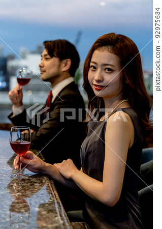 Couple drinking champagne at bar counter 92975684