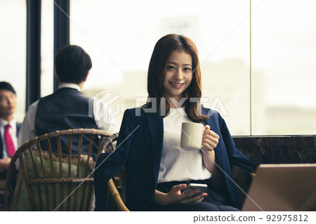 Businesswoman working in the lounge Businesswoman working in the lounge 92975812