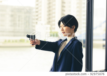 Criminal holding a handgun 92975876