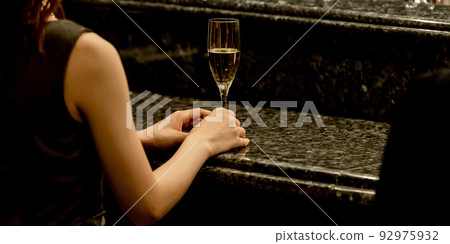 A woman sitting at a counter 92975932