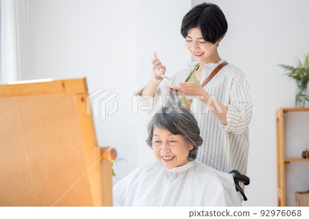 Senior woman having her hair taken care of by a hairdresser Senior woman having her hair taken care of by a hairdresser 92976068
