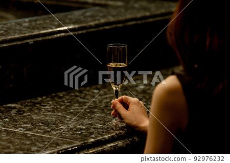 A woman sitting at a counter 92976232