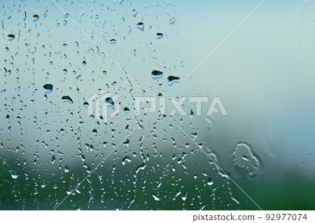 Rain drops on window in a close up 92977074