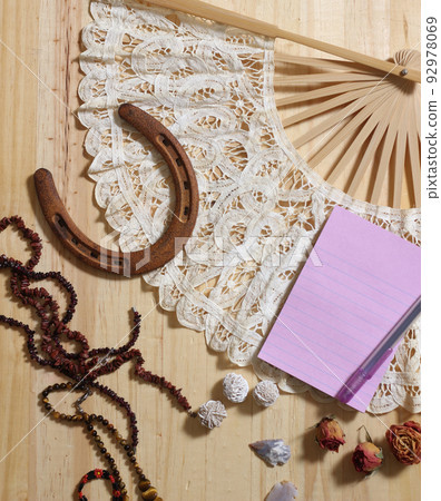 Horseshoe With Vintage Lace Fan Beads and Arrowheads on Wooden Background 92978069