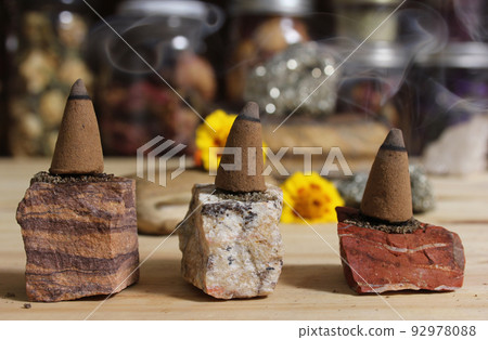 Incense Cones and Chakra Stones With Flowers in Background Shallow DOF Incense Cones and Chakra Stones With Flowers in Background Shallow DOF 92978088