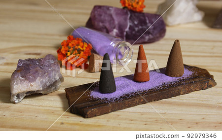 Incense Cones on Stone Slab With Crystals and Flowers 92979346