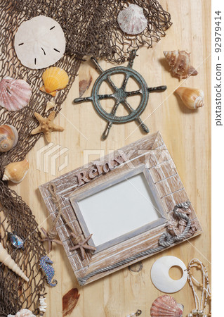 Empty Frame on Wooden Background With Sea Shells and Fishing Net. Nautical and Coastal Theme 92979414