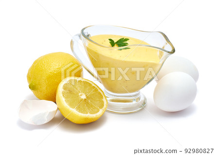 Tasty yellow hollandaise sauce in glass bowl gravy boat isolated on white background 92980827