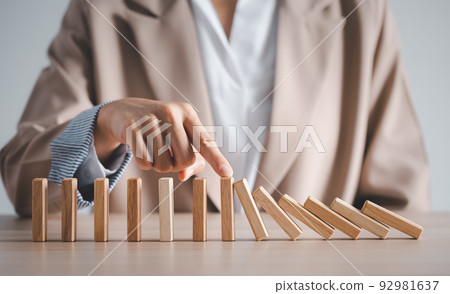 wood block row fallen by woman finger 92981637