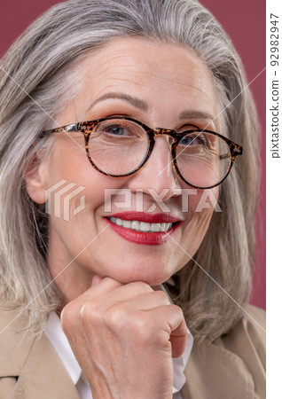 Close up of a pampered mature woman in eyeglasses Close up of a pampered mature woman in eyeglasses 92982947