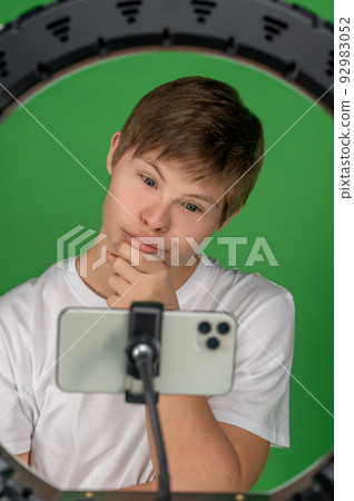 Modern boy taking selfies with a ring light 92983052