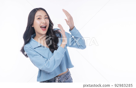 Excited asian woman casual holding hand shocked surprised sale product with copy space over white Excited asian woman casual holding hand shocked surprised sale product with copy space over white 92983285