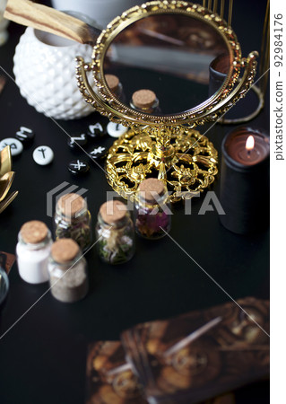 Blurred esoteric magic objects tarot cards on witch table altar Blurred esoteric magic objects tarot cards on witch table altar 92984176