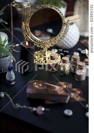 Blurred esoteric magic objects tarot cards on witch table altar Blurred esoteric magic objects tarot cards on witch table altar 92984192