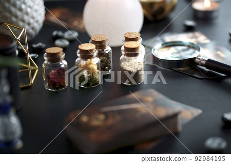 Blurred esoteric magic objects tarot cards on witch table altar 92984195