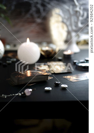 Blurred esoteric magic objects tarot cards on witch table altar 92984202