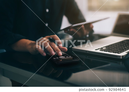 Businessmen are calculating income-expenditure and analyzing real estate investment data at office, Accounting Financial and tax systems concept. Businessmen are calculating income-expenditure and analyzing real estate investment data at office, Accounting Financial and tax systems concept. 92984641