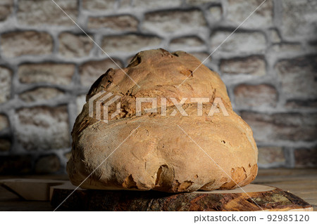The bread of Matera, Pane di Matera on rustic wooden background, typical southen italian sourdough bread, close up The bread of Matera, Pane di Matera on rustic wooden background, typical southen italian sourdough bread, close up 92985120