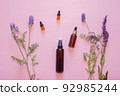 Flat lay composition with lavender flowers and natural cosmetics on a pink background. 92985244