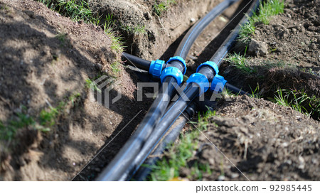 Installed PVC water pipes in trench at summer cottage Installed PVC water pipes in trench at summer cottage 92985445